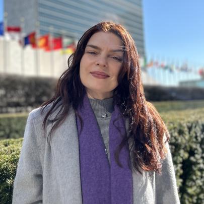 Portrait of Olga standing outside UNHQ in New York 